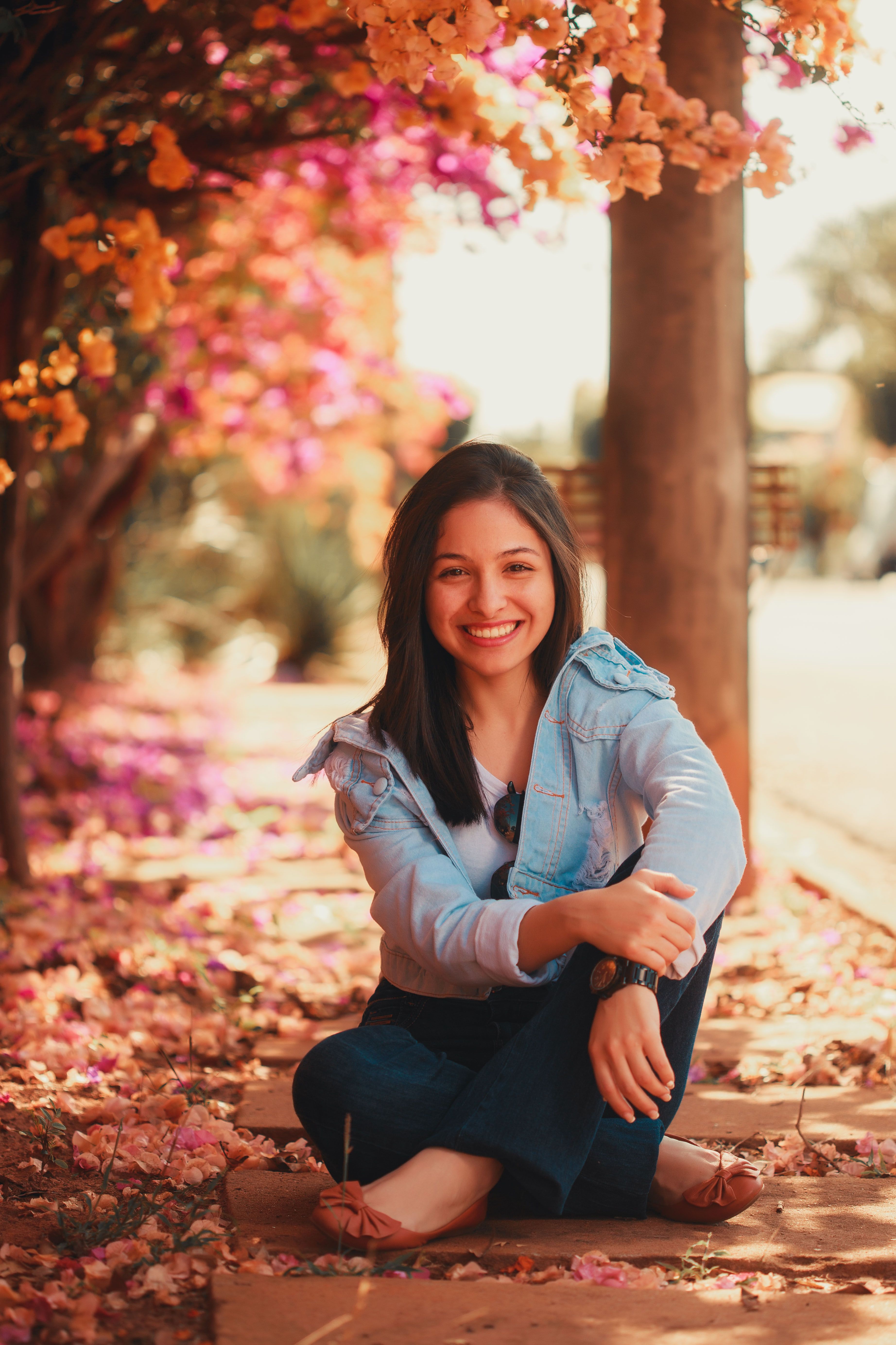 A Woman in Denim Jacket Sitting on a Concrete Structure · Free Stock Photo