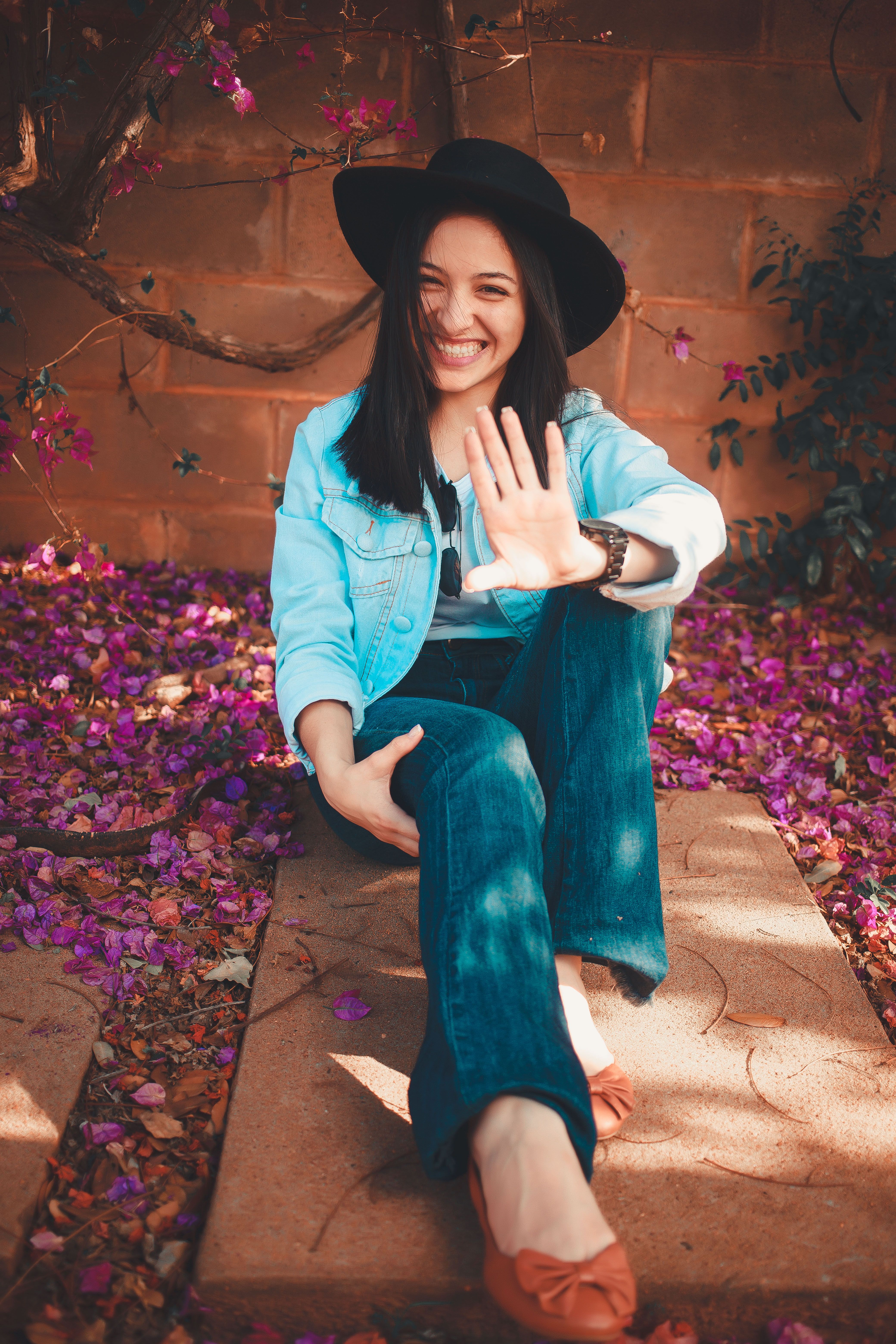 Beautiful Woman in Black Hat Sitting on Floor · Free Stock Photo