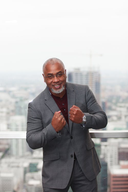 Free Smiling Man in Formal Wear on Balcony Stock Photo