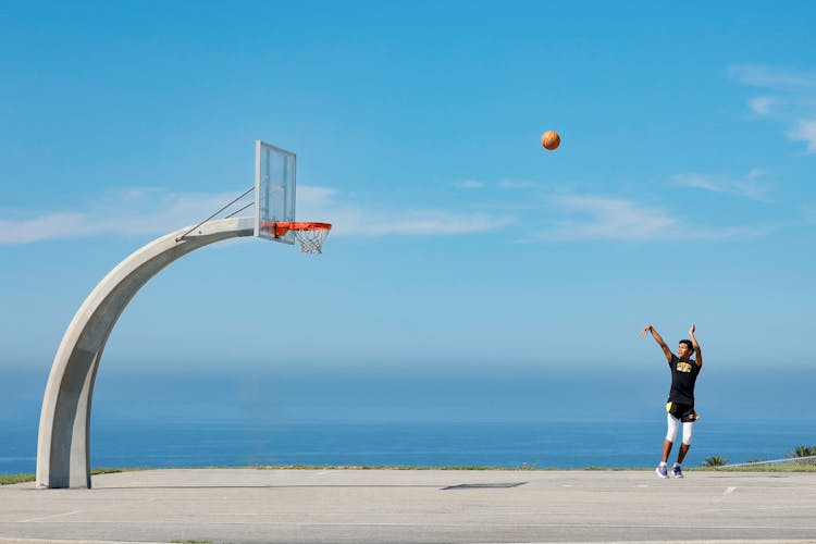 A Man Shooting A Ball