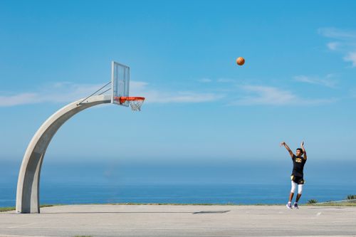Free Athlete practicing basketball jumpshot on outdoor court overlooking the ocean in Rancho Palos Verdes. Stock Photo