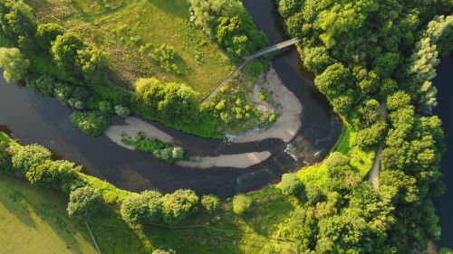 Free Aerial shot of a river bend with lush greenery in Greater Manchester, England. Stock Photo