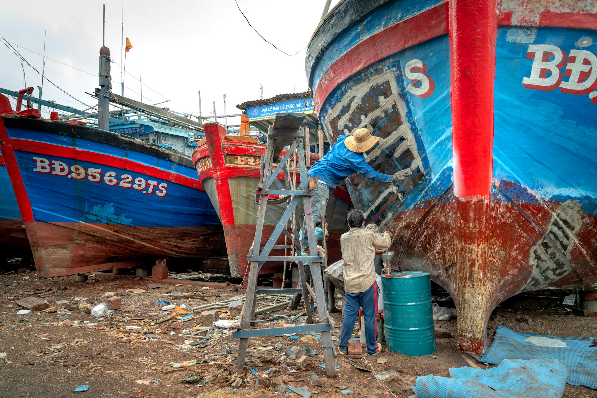 A People Repairing a Boat