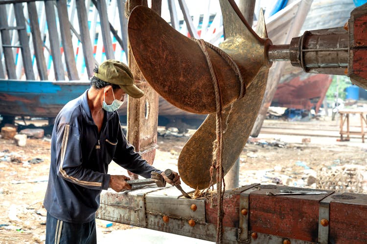 Man Fixing A Ship