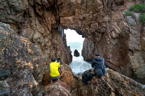 Photographers on a Cave at a Beach