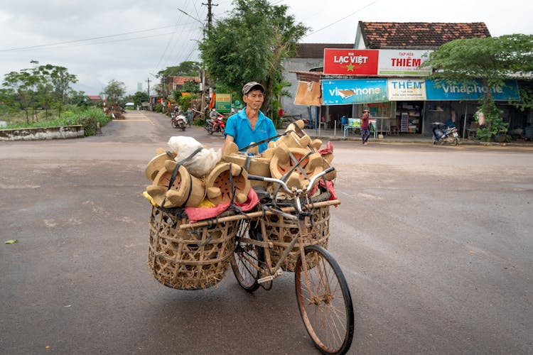 Man Riding On A Bicycle Transporting Of Goods