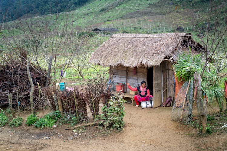 A Woman Weaving A Basket