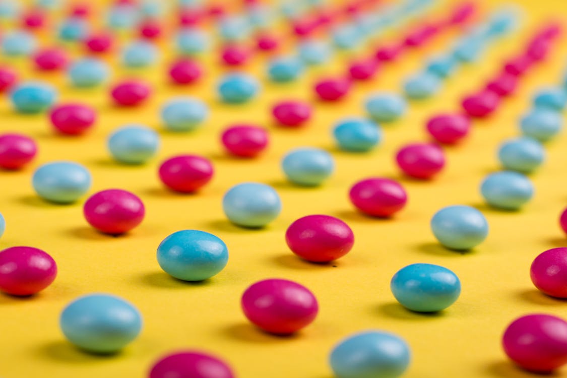 Selective Focus Photo of Round Pink-and-blue Beads