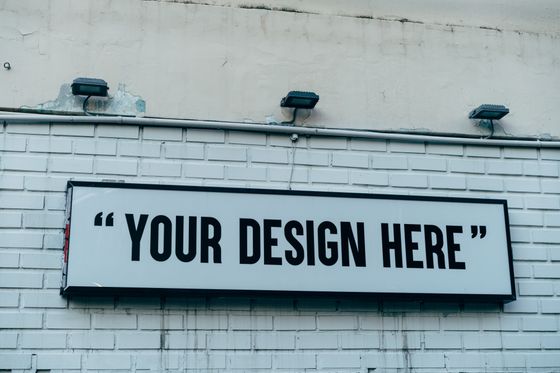 Blank illuminated sign on a brick wall — photo by Markus Winkler on Pexels