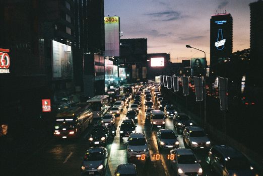 Aerial view of heavy traffic on a city street in the Philippines during twilight.