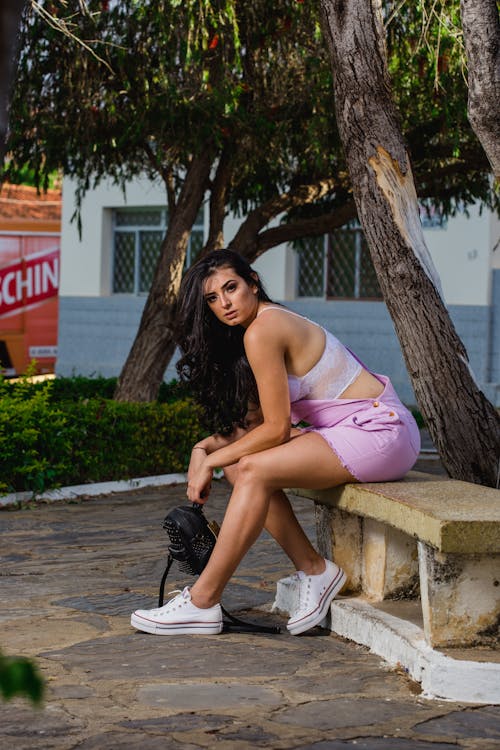 Woman Sitting on Bench Outdoors