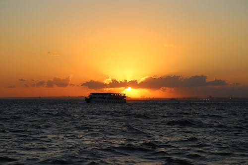 Silhouette Photography of Cruiser Ship on Body of Water during Sunset