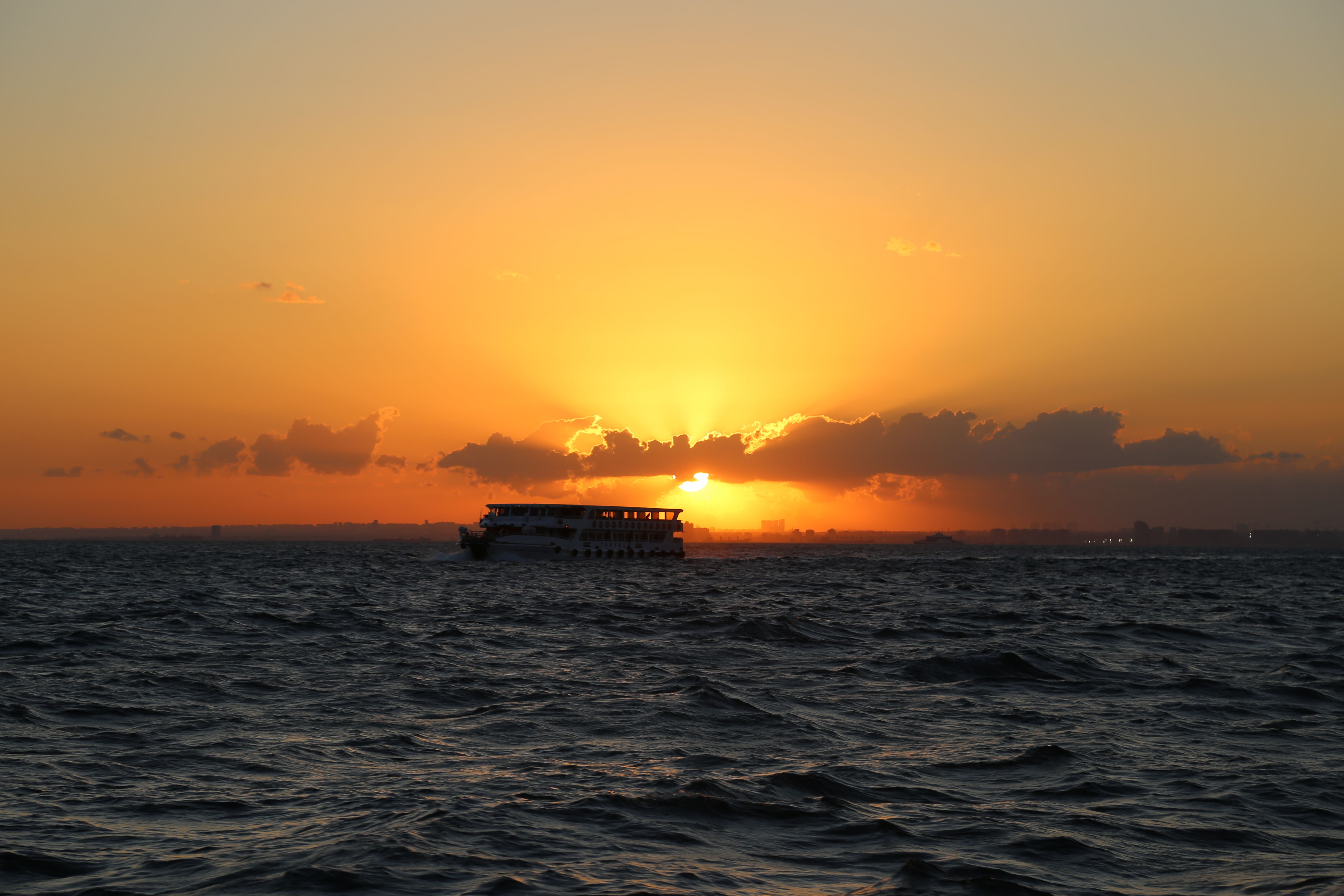 Silhouette Photo of Boat on Ocean during Golden Hour · Free Stock Photo