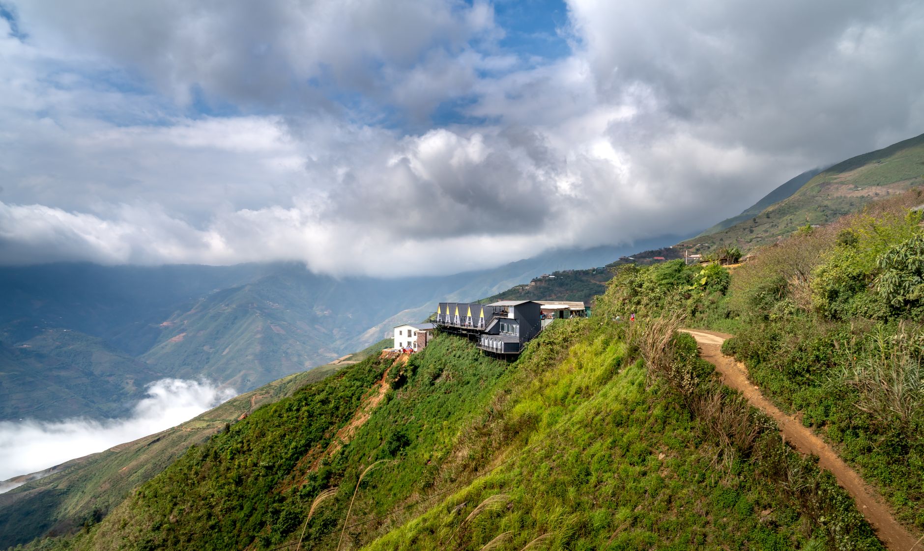 A minimalist ultra-luxury villa seamlessly integrated into a vast, untouched wilderness landscape under a twilight sky.