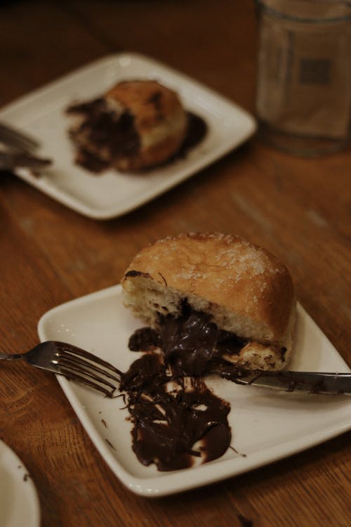 Free Donut with Chocolate Filling on Plate Stock Photo