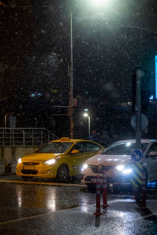 Free Yellow taxi and car in the rain on a night street in Üsküdar, İstanbul. Stock Photo