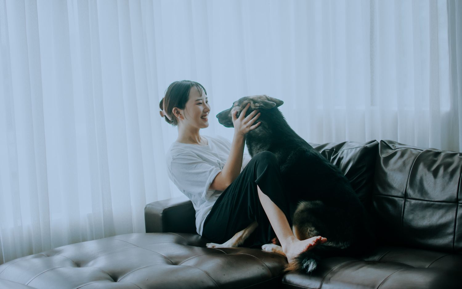 Pet parent relaxing with dog