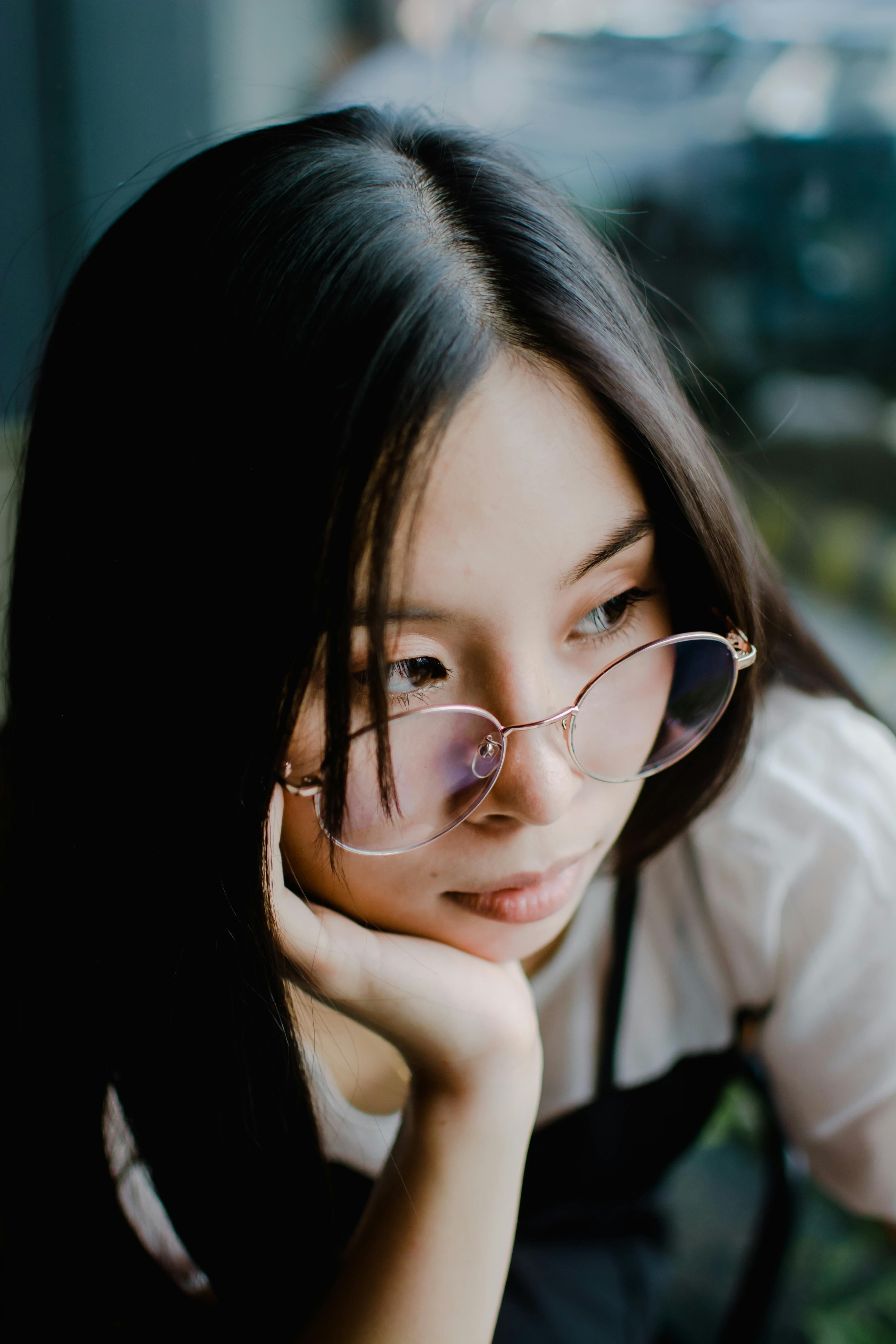 Pensive Woman in Glasses Looking Aside · Free Stock Photo