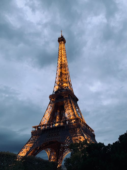 Illuminated Eiffel Tower Under Gray Cloudy Sky