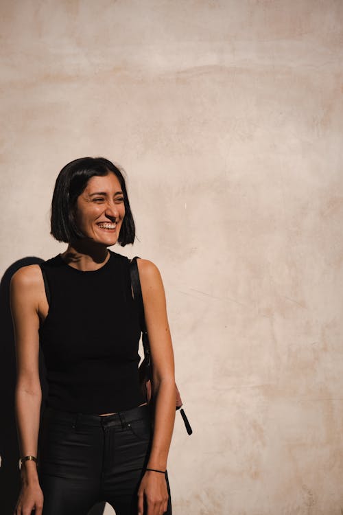 Woman in a Black Sleeveless Top Smiling