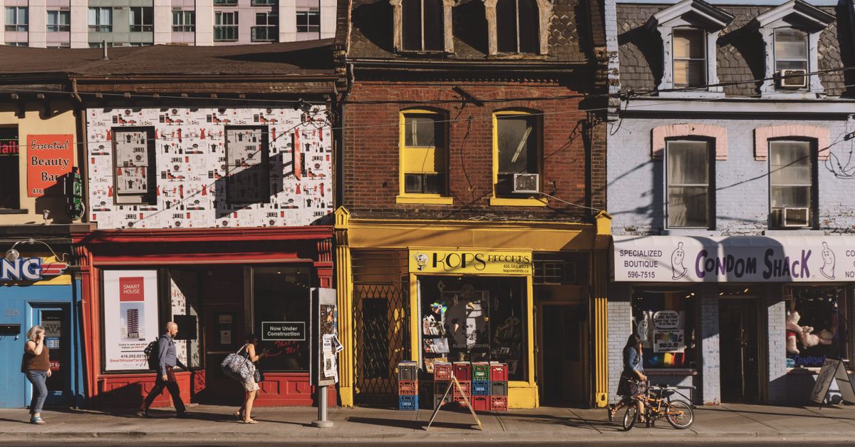 A busy street near UHAS with students walking and small shops