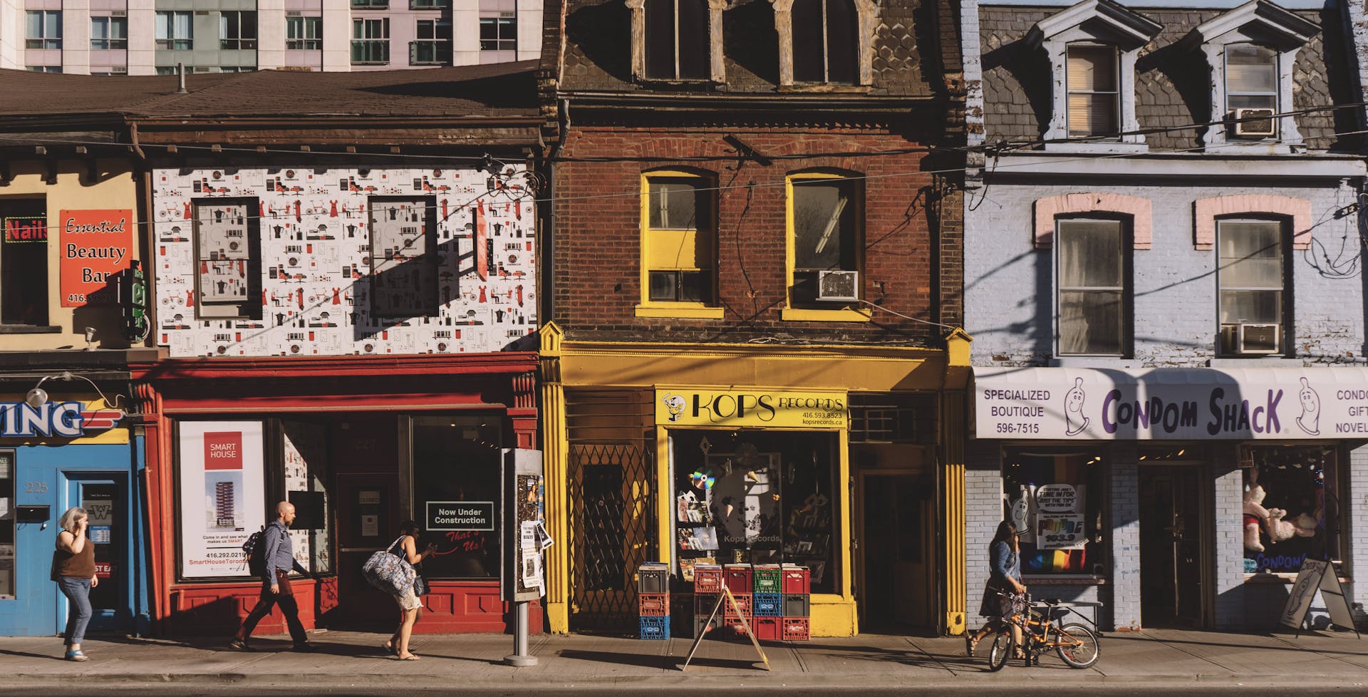 People Walking in Front of Storefronts