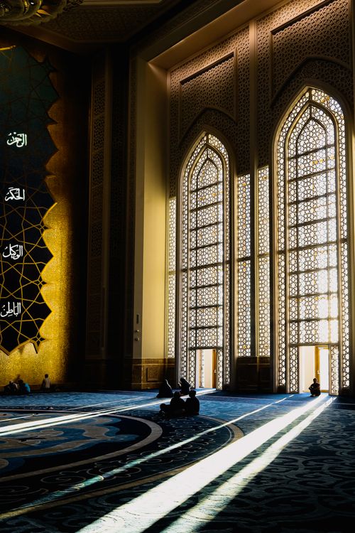 Free Illuminated mosque interior with intricate designs and light patterns on the floor. Stock Photo
