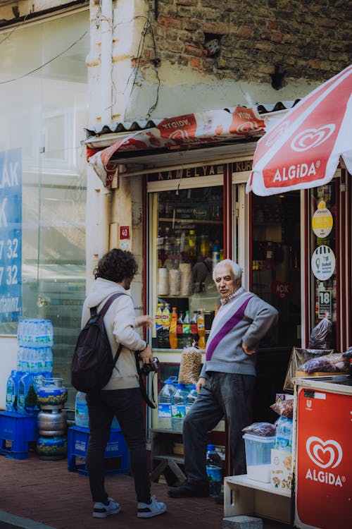 Men Talking in Front of a Store