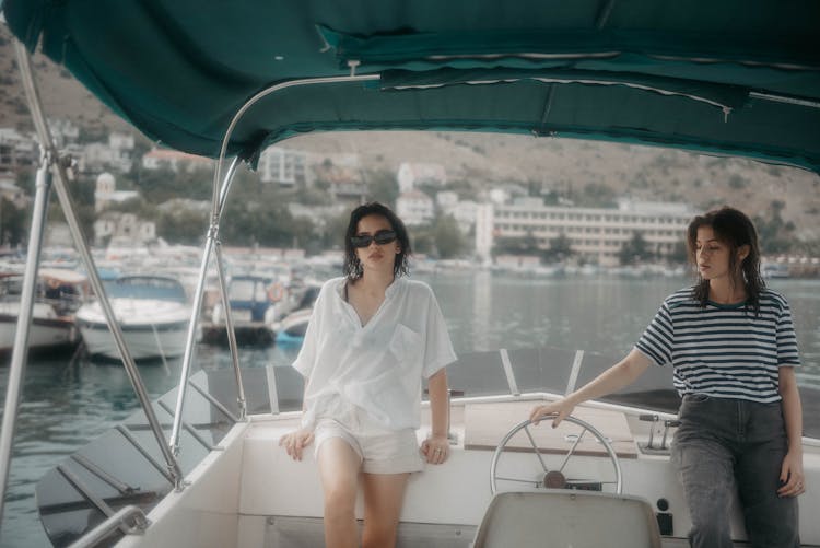 Two Women Leaning On A Boat