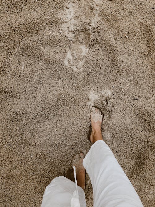 Person Walking on Sand