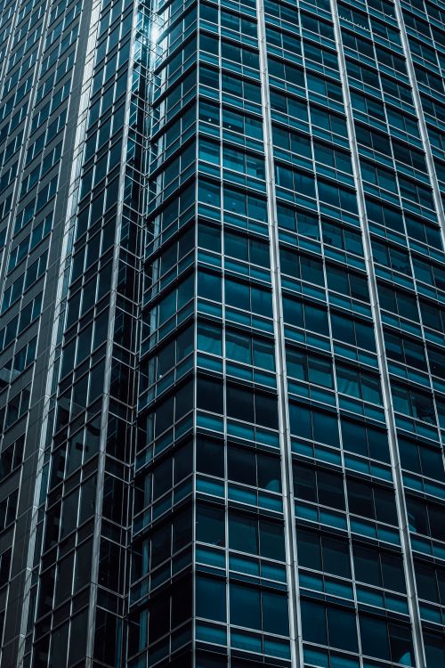 Free A detailed view of a modern glass skyscraper's exterior showcasing its architectural design. Stock Photo