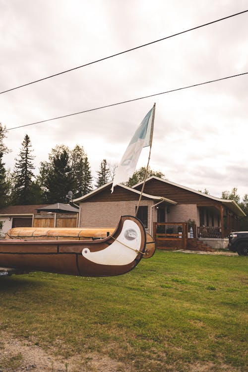 Bungalow and Wooden Vintage Boats in a Yard