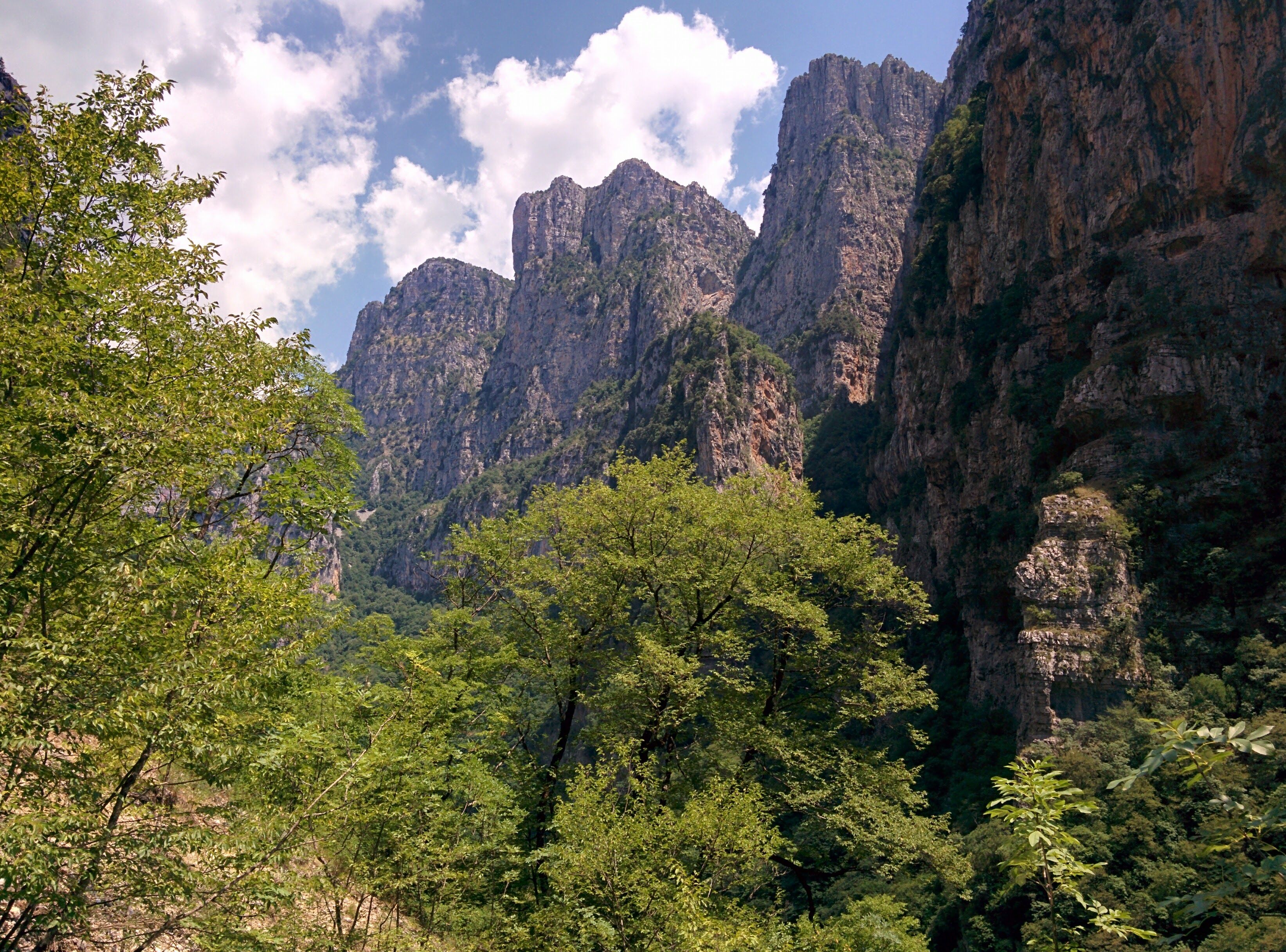 Explore the breathtaking cliffs and lush greenery of Vikos Gorge, Greece. Explore the breathtaking cliffs and lush greenery of Vikos Gorge, Greece.