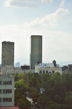 Scenic aerial view of Ciudad de México's iconic skyline including skyscrapers and lush greenery.