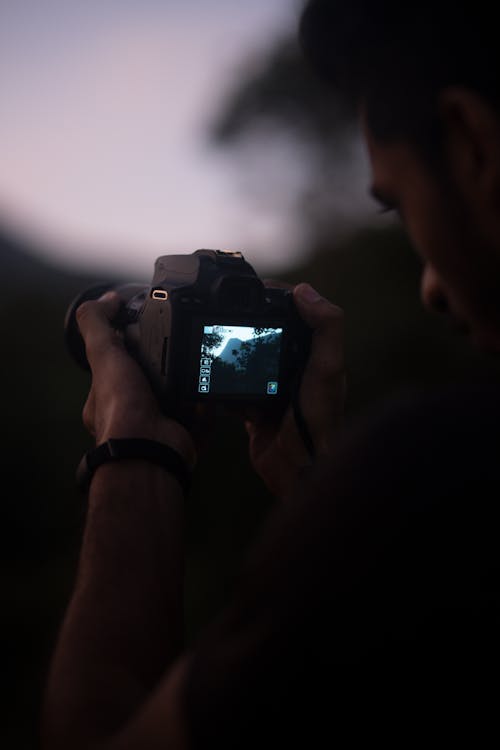 Close Up Photo of Man Taking Photo with a Camera