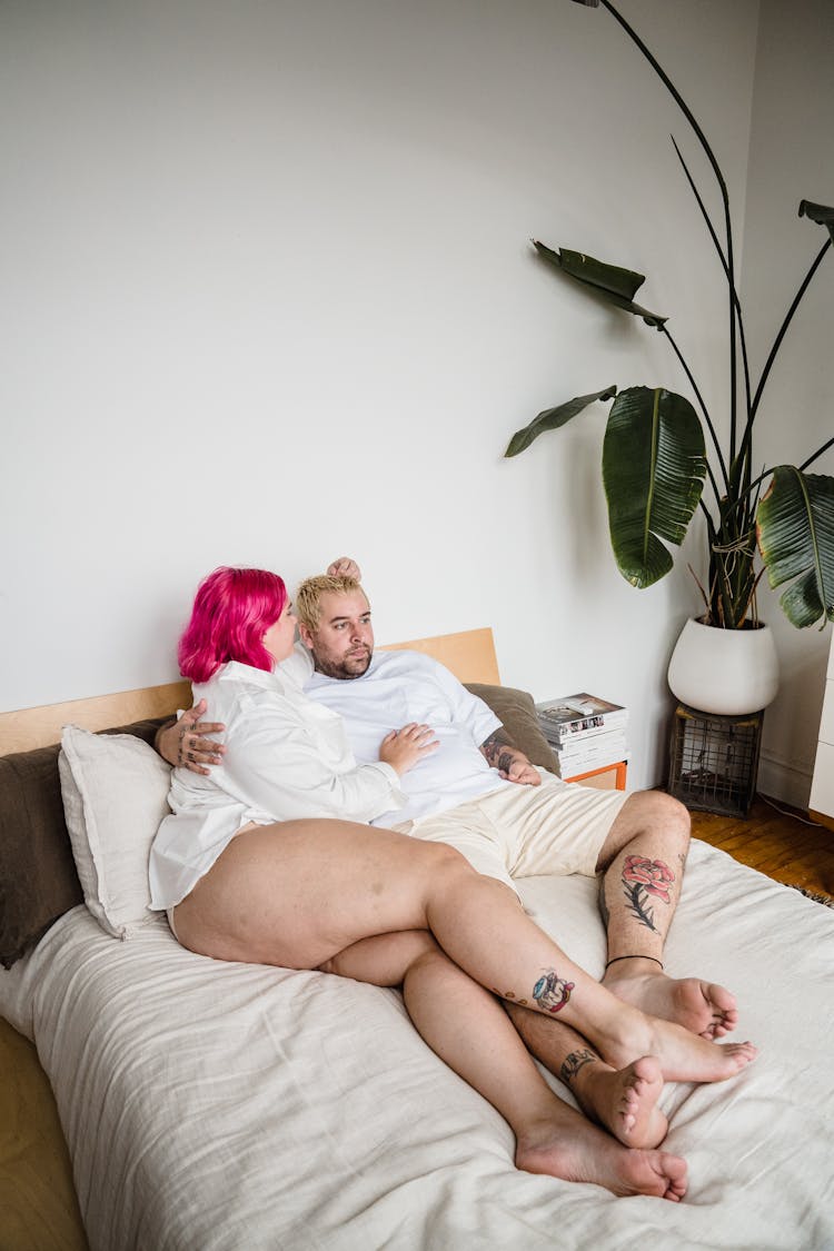 Couple Lying In Bed At Home