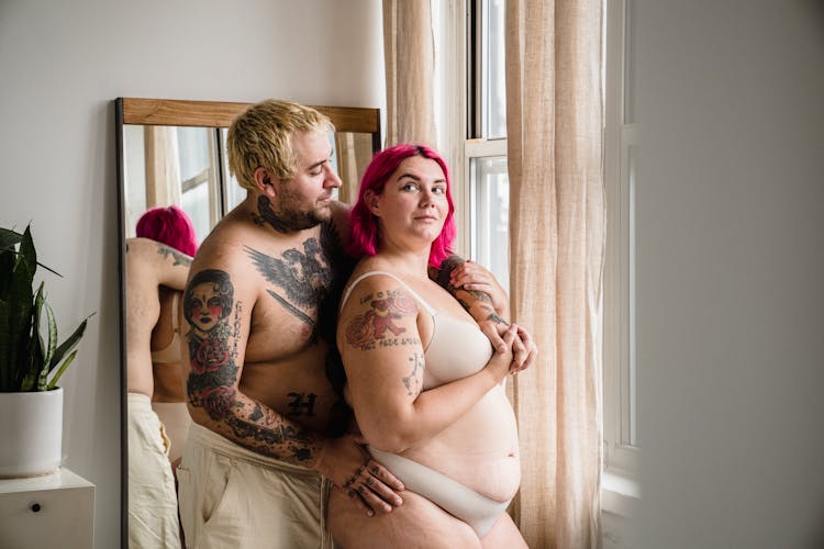 Body Positive Couple With Tattoos Hugging