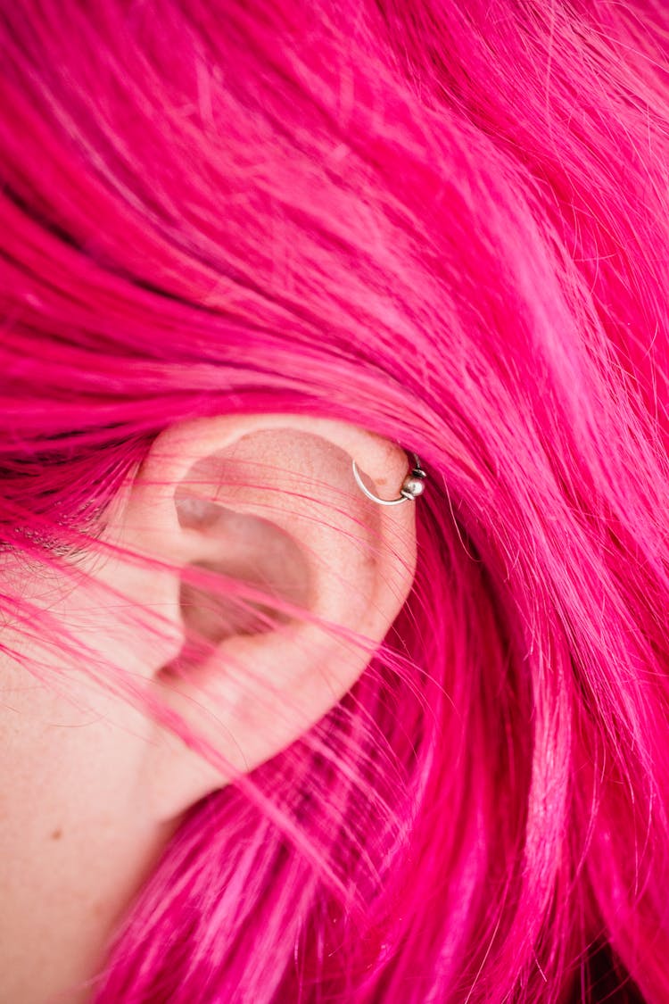 Close-up Of Womans Ear And Pink Hair 