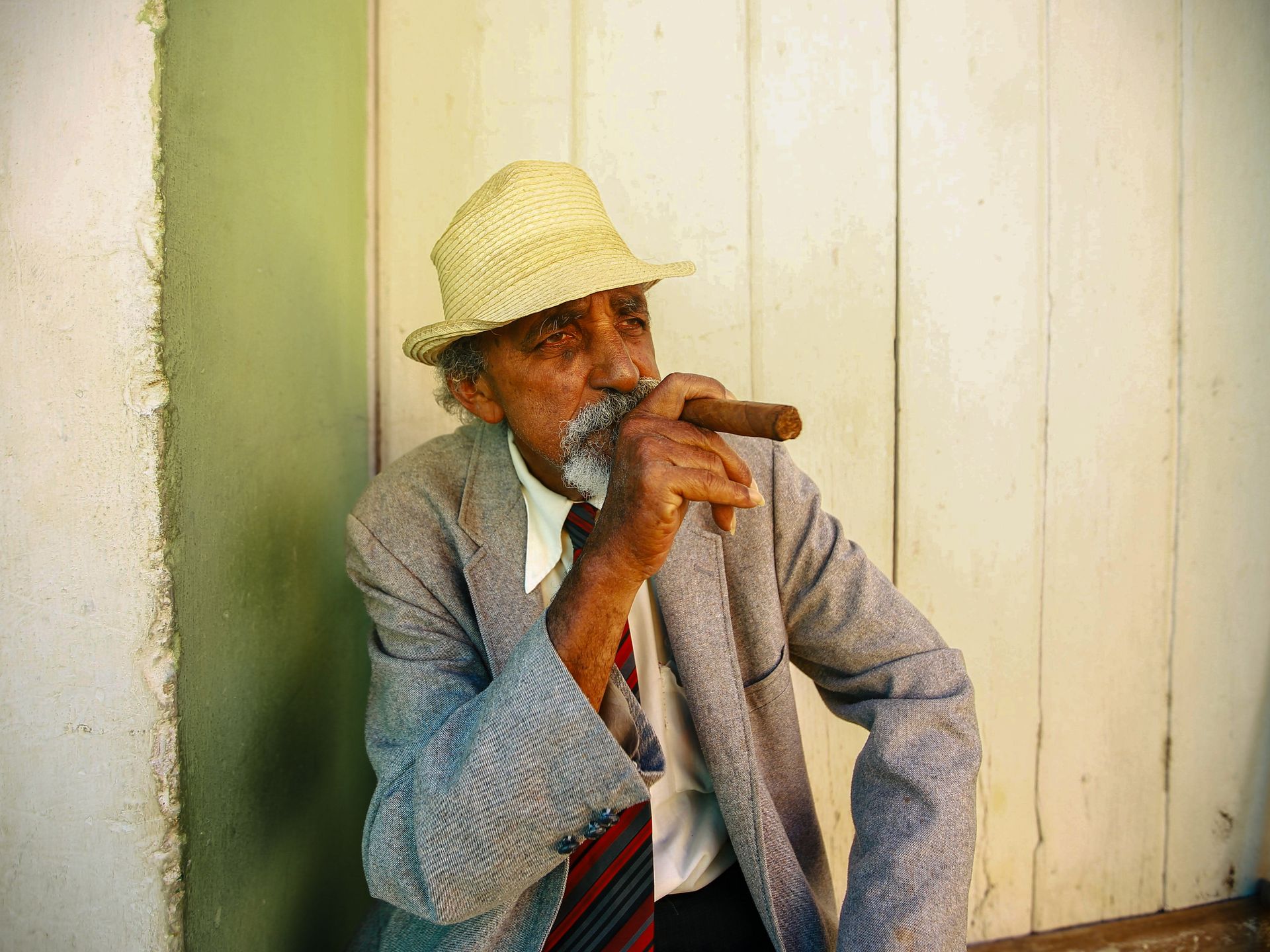 Man in a Gray Suit Holding a Cigar