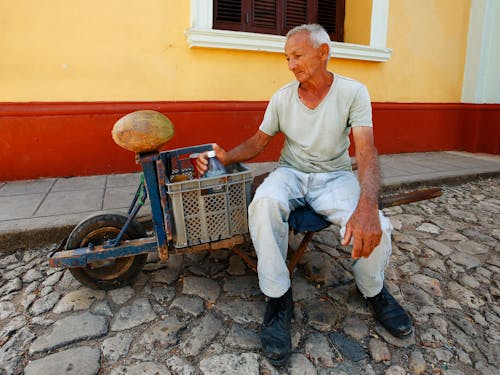 Free Photo of an Elderly Man Sitting on a Cart Stock Photo