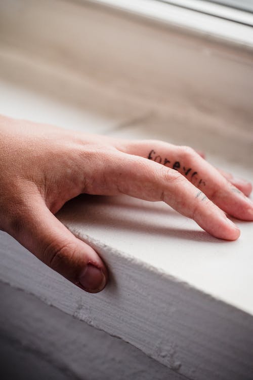 Free Close-up of a Hand with a Finger Tattoo  Stock Photo