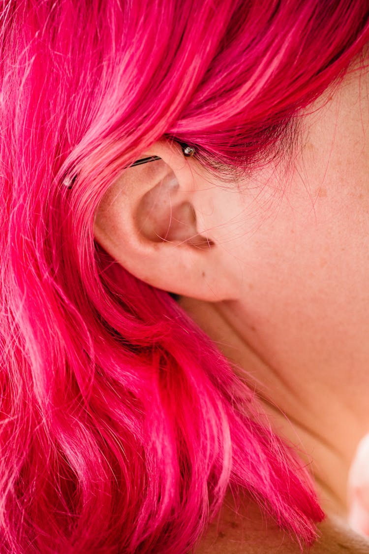 Close-up Of Womans Ear And Pink Hair