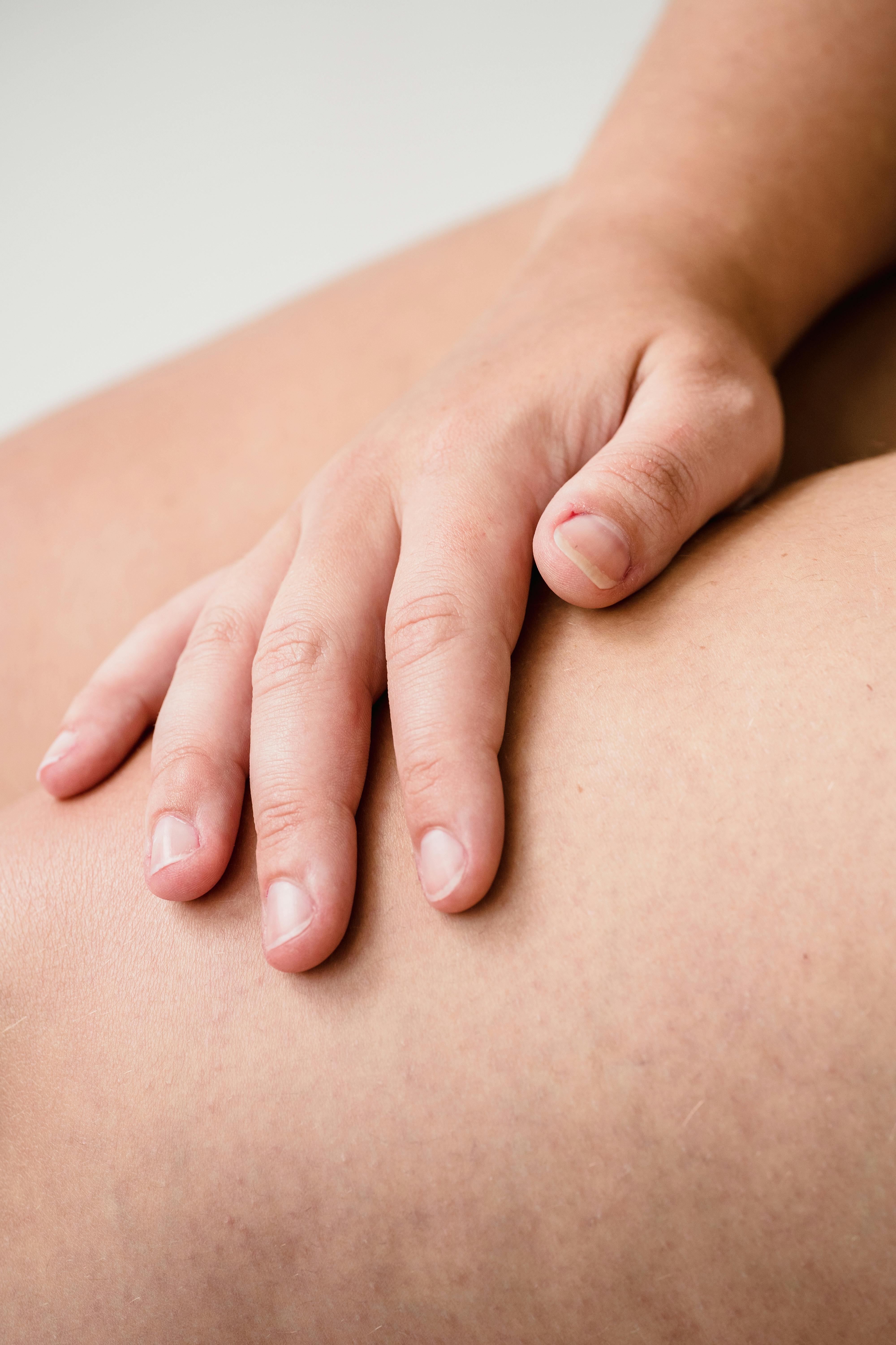 close up of hand touching bare skin