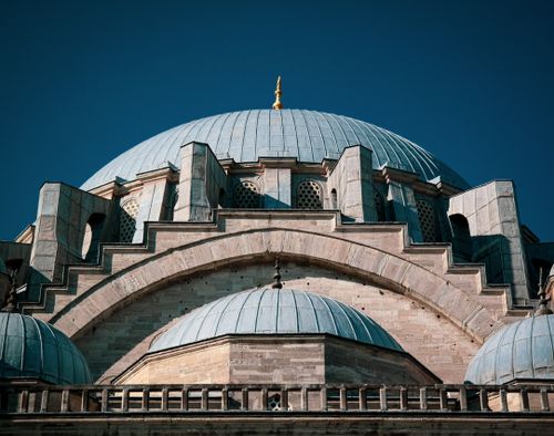 Free Close-up of Suleymaniye Mosque dome with blue sky, highlighting intricate architecture. Stock Photo