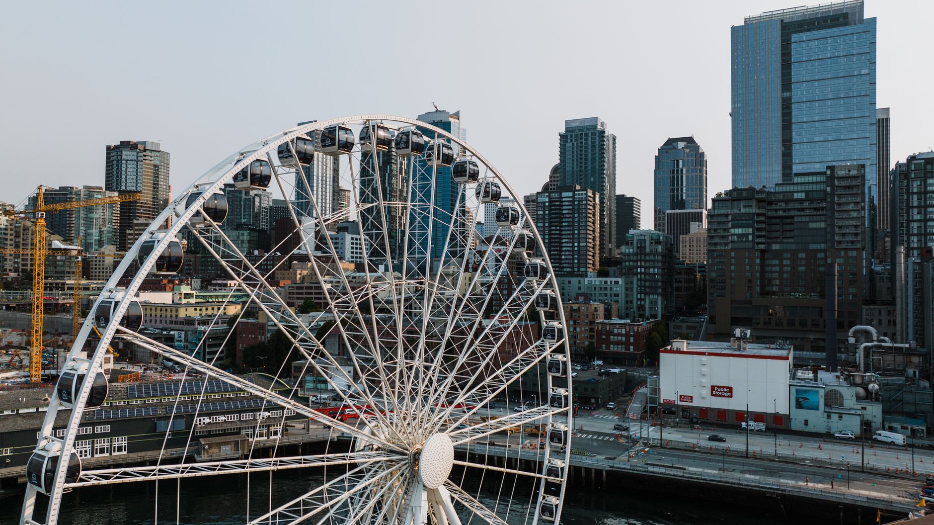 A panoramic view of the Seattle Great Wheel against the urban skyline, capturing iconic architecture.