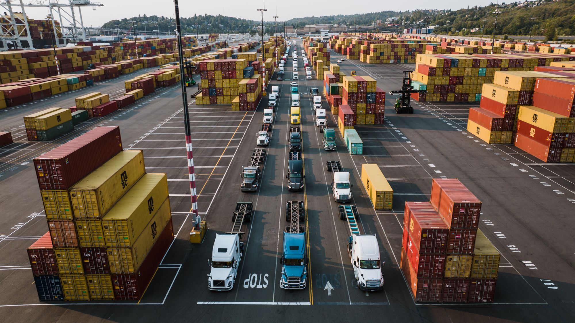 Freight trucks and cargo containers at a shipping port