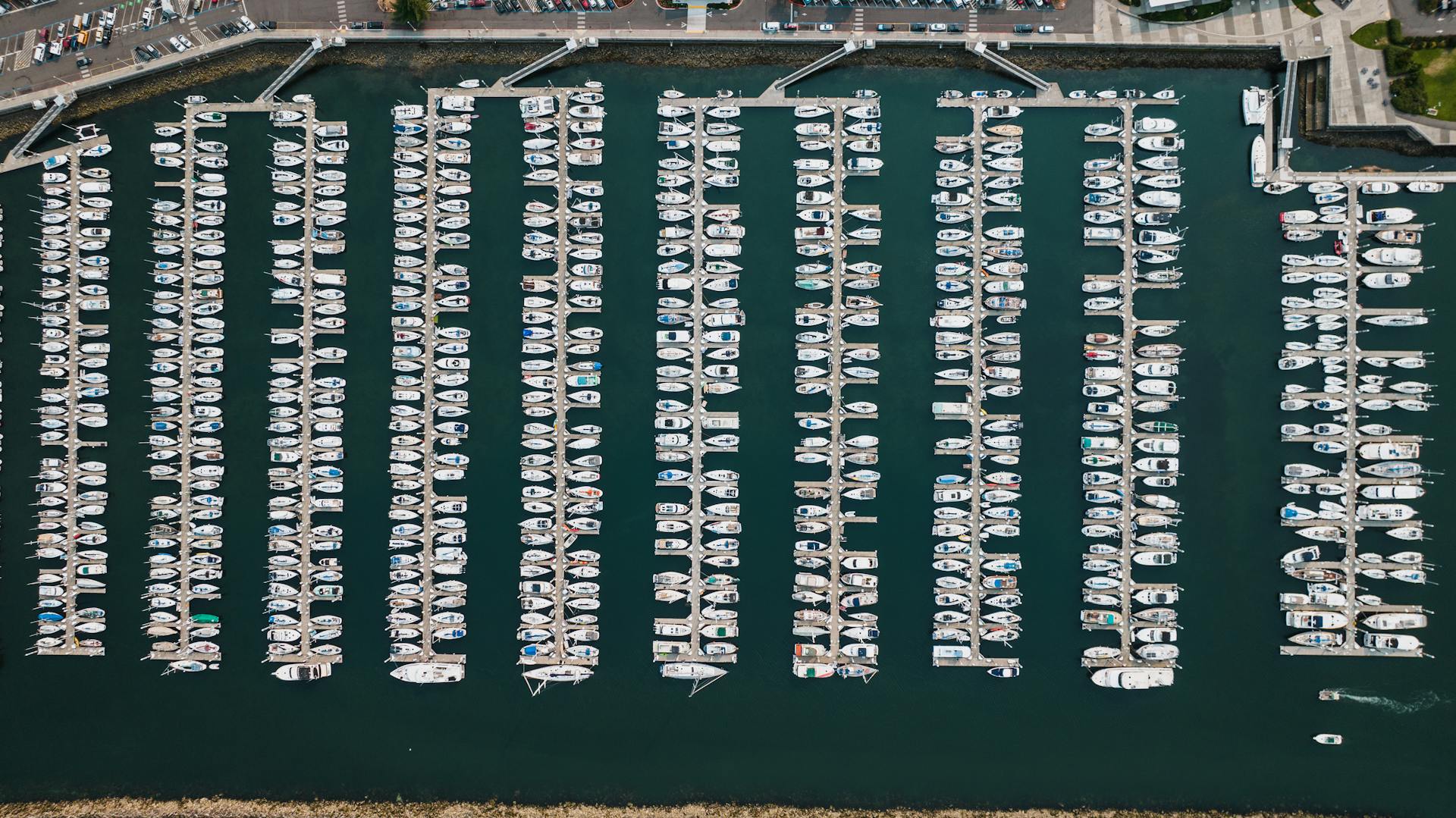 Aerial drone shot of a bustling marina in Seattle, showcasing neatly docked boats.