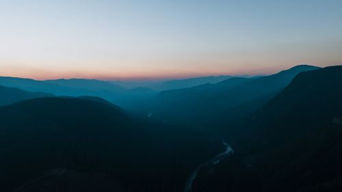 Free Tranquil aerial view of Greenwater mountains at twilight, with serene dusk hues and fog in the distance. Stock Photo