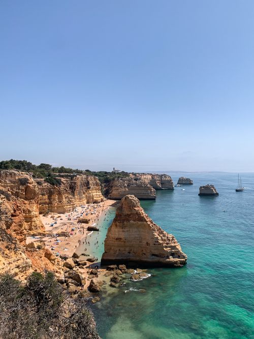 Free A breathtaking view of Algarve's cliffs and turquoise waters along the Faro District's coastline. Stock Photo