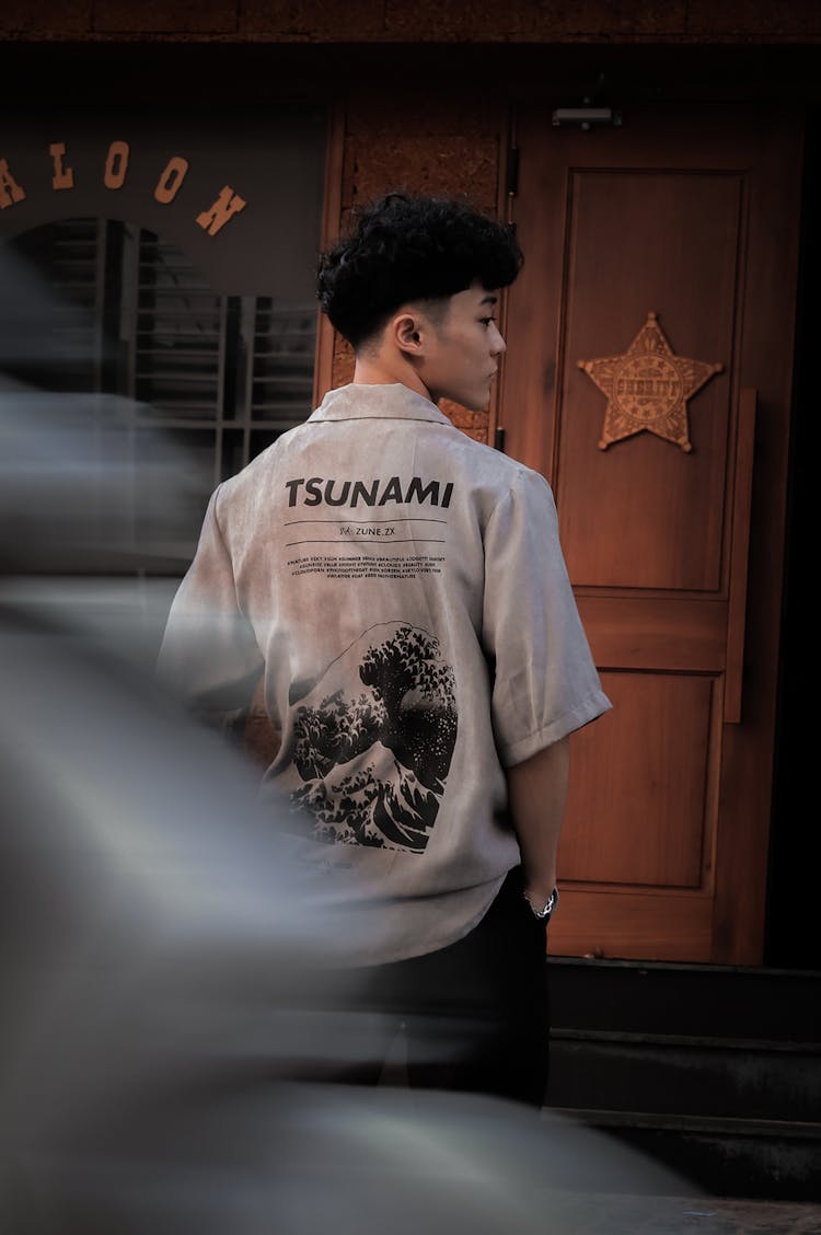 Teenager Boy Standing In Front Of A Saloon